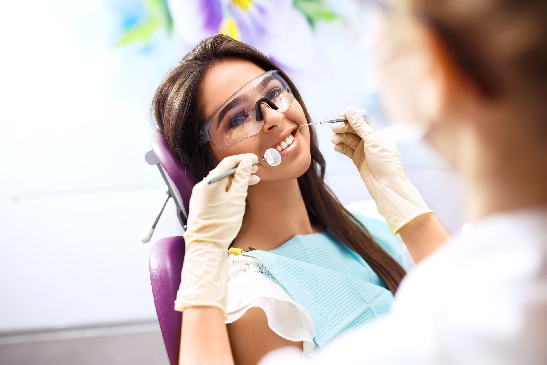 Beautiful woman at the dentist getting her teeth checked - oral health concepts