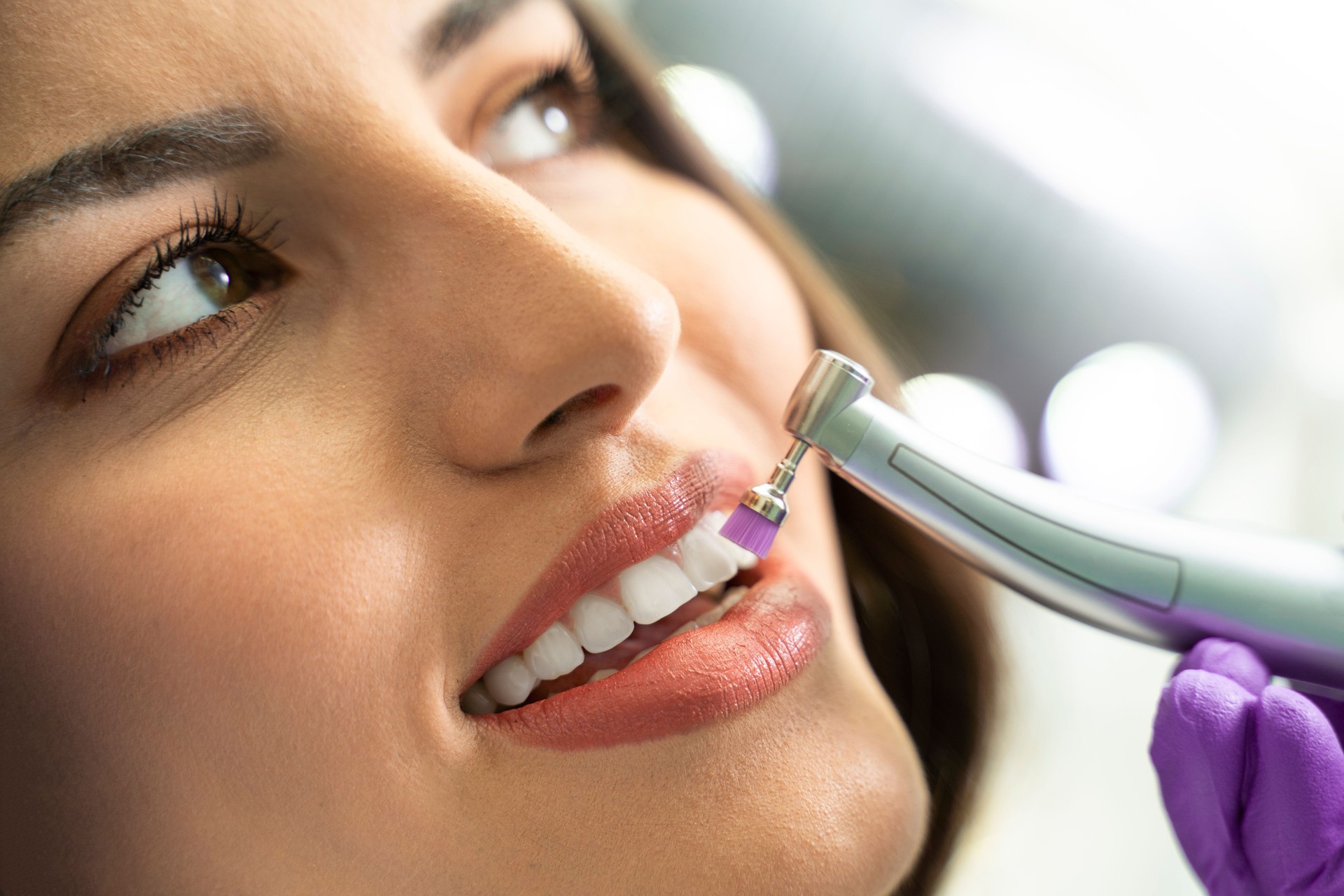 young woman getting her teeth polished
